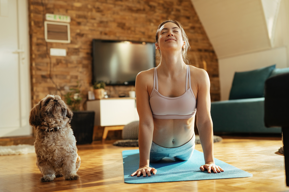 Smiling,Athletic,Woman,In,Cobra,Pose,Practicing,Yoga,With,Her